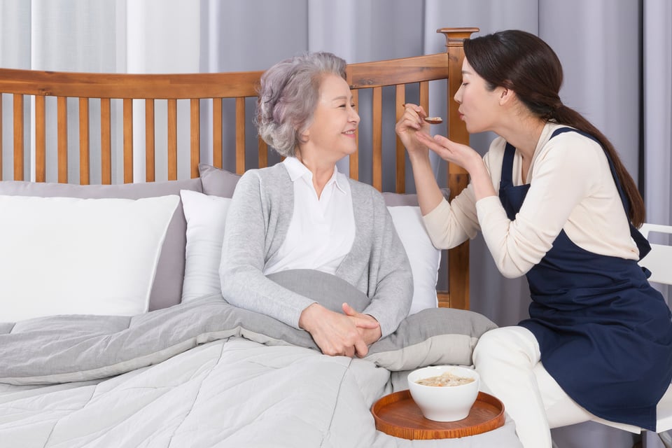 Asian caregiver and old woman at nursing home